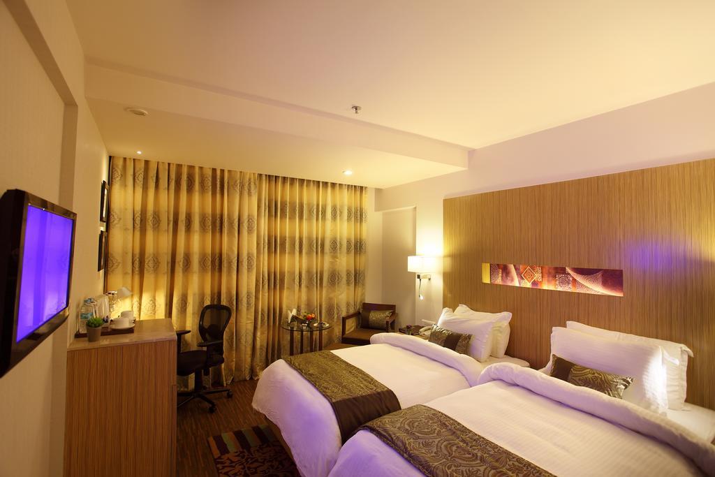 Comfort Inn Legacy Rajkot Rum bild